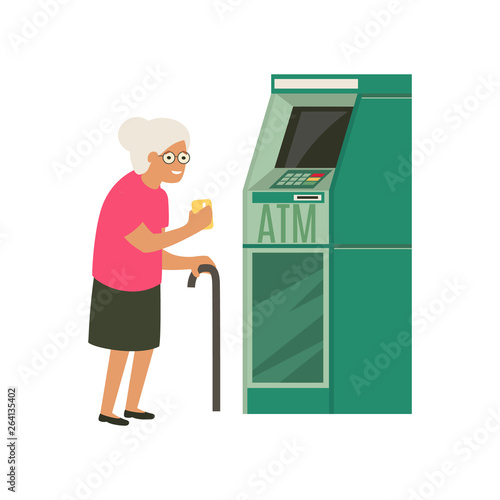 Senior withdrawing money from credit card at ATM.