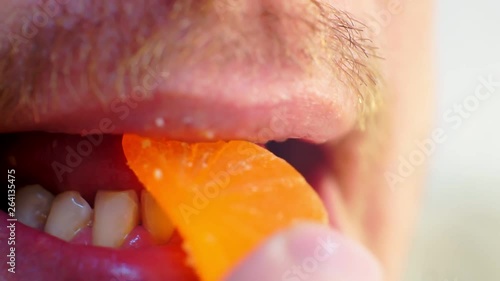Wallpaper Mural hungry men eating bright gummy candy marmalade.male mouth extreme closeup.shallow depth of field. Torontodigital.ca