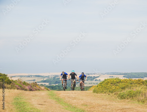Mountain bikers ride uphill together
