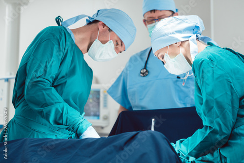 Fotografie, Obraz Medical doctors performing operation in hospital