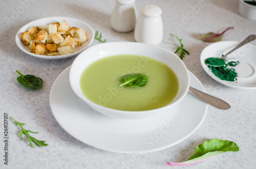 Fresh green Vegetable cream soup. Green Broccoli cream soup on white bolw on the white background