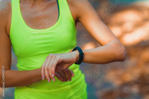 Woman Looking at Smart Watch after Outdoor Training