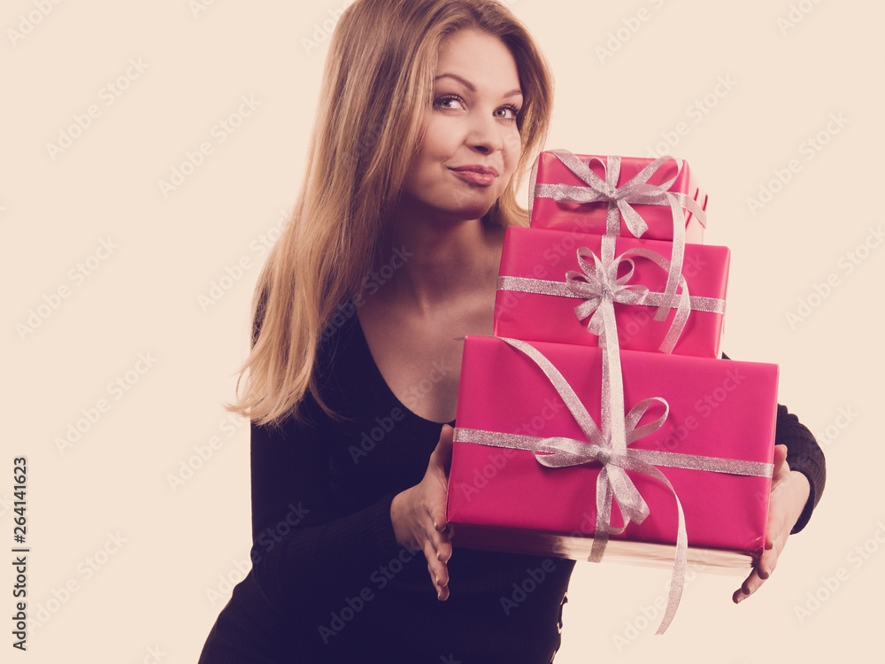 Girl holding stack of pink gift boxes Girl holding stack of pink gift boxes