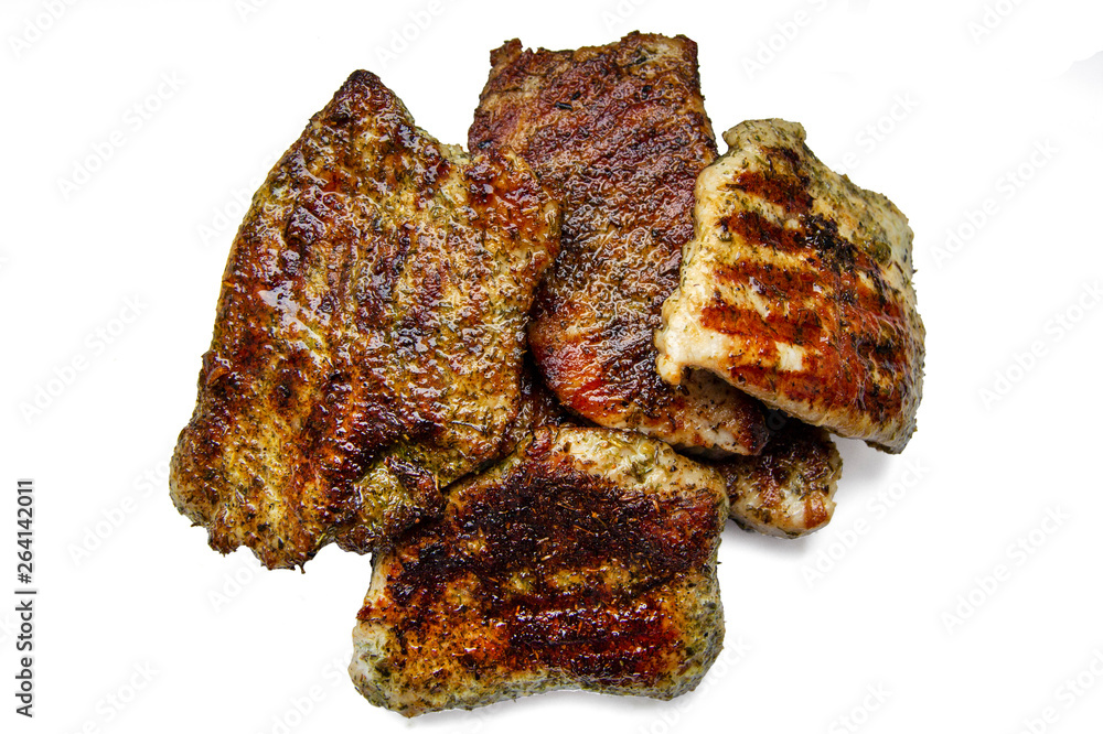 Fried pieces of meat with spices on white background, isolated