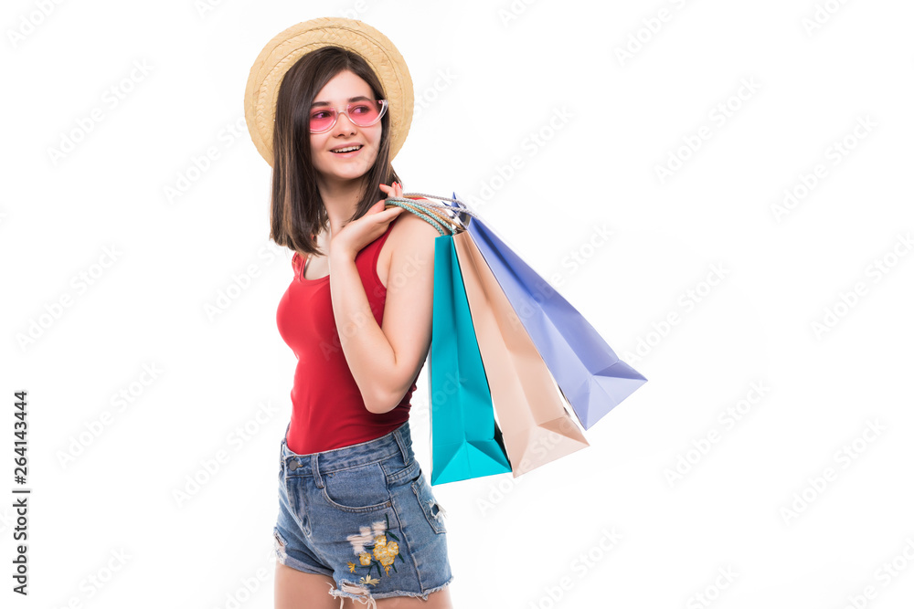 Colourful shopping vibes. Full length portraits of smiling brunette woman in hat and bright clothes with shopping bags isolalted on white background
