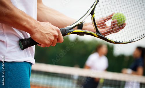 Fit happy poeple playing tennis together. Sport concept © NDABCREATIVITY