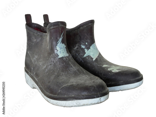 old dirty, rubber boots on white background.