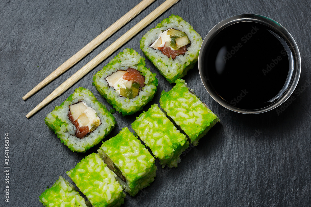 Japanese sushi rolls with tuna and cream cheese served on black stone slate Japanese sushi rolls with tuna and cream cheese served on black stone slate