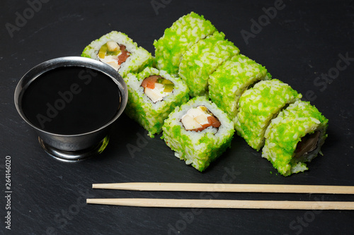 Japanese sushi rolls with tuna and cream cheese served on black stone slate
