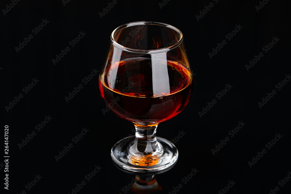 Glass of brandy on a black background Glass of brandy on a black background