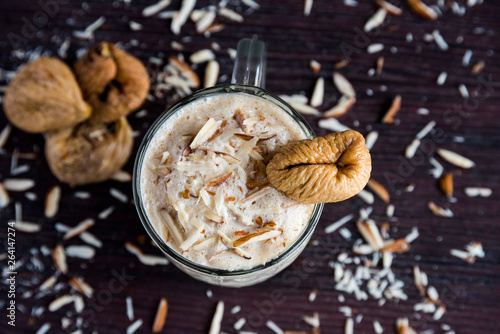 Anjeer milk shake or dried fig milk shake with almonds - selective focus