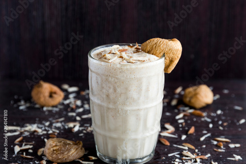 Anjeer milk shake or dried fig milk shake with almonds - selective focus