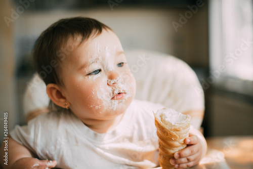 baby in the kitchen eagerly eating the delicious cream horns  filled with a vanilla cream