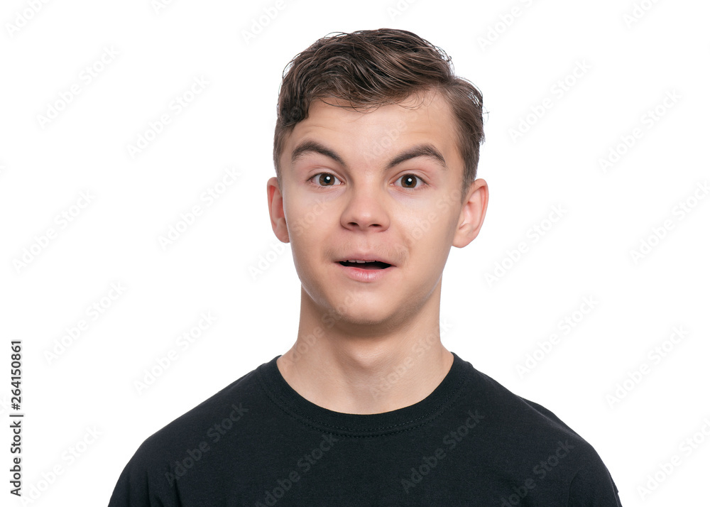 Emotional portrait of caucasian teen boy, isolated on white background. Funny child teenager looking at camera and shocked. Handsome surprised boy in black t-shirt. Emotional portrait of caucasian teen boy, isolated on white background. Funny child teenager looking at camera and shocked. Handsome surprised boy in black t-shirt.