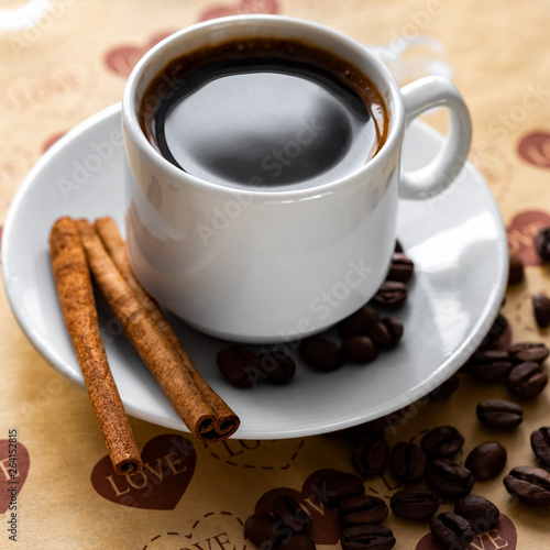 a Cup of natural coffee beans and cinnamon