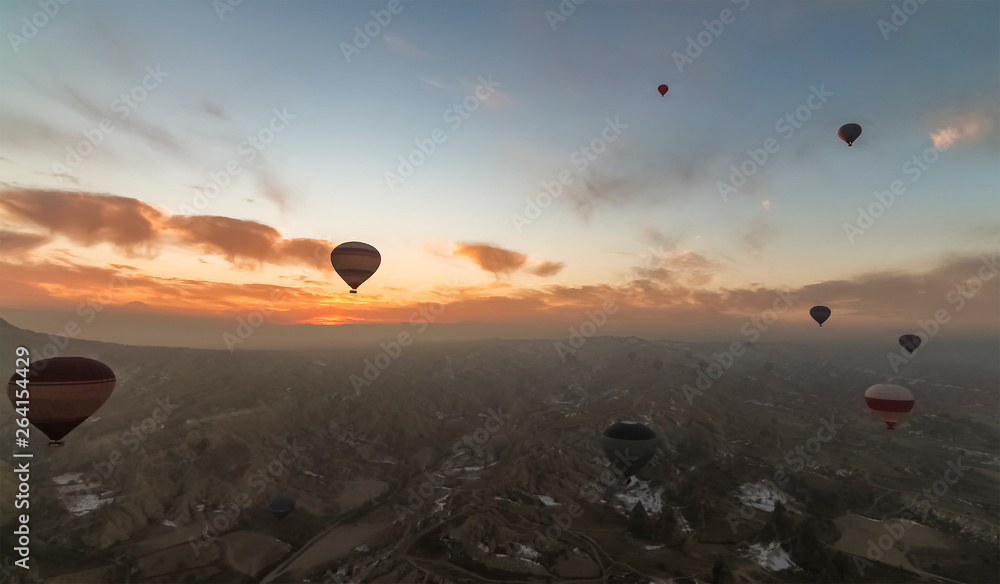 Aerial view of Cappadocia at sunrise with hot air balloons Aerial view of Cappadocia at sunrise with hot air balloons
