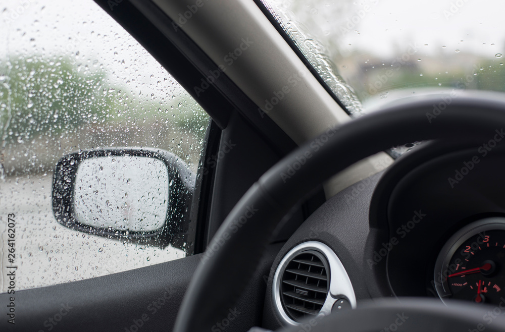 Rain drops on car glass. Spring rain
