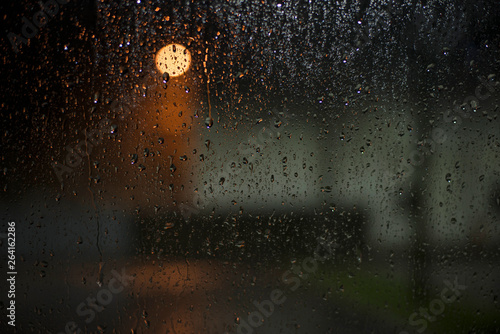 Rain drops on the car glass in the night.