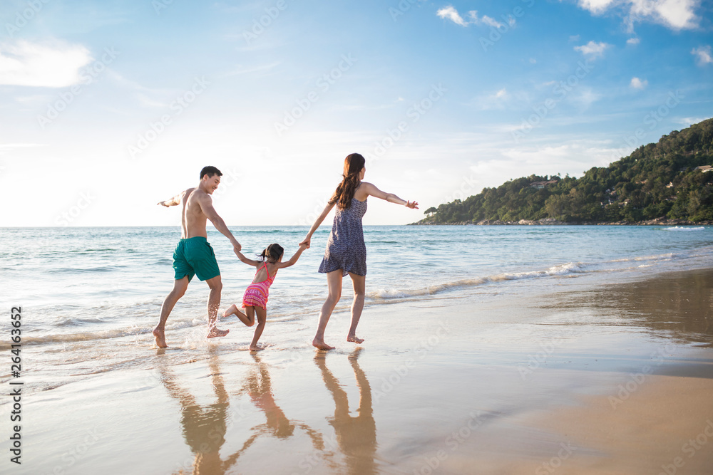 Happy young family having fun on beach Happy young family having fun on beach