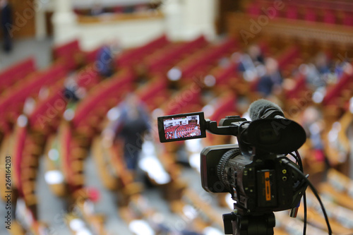 The camcorder stands on a tripod and removes the meeting room