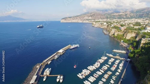 Aerial top down view of the arrival of the ship with tourists in the port bay. sea transport. Sorrento city, tourism concept, vacation in Europe, Italy