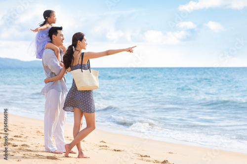Happy young family by the sea