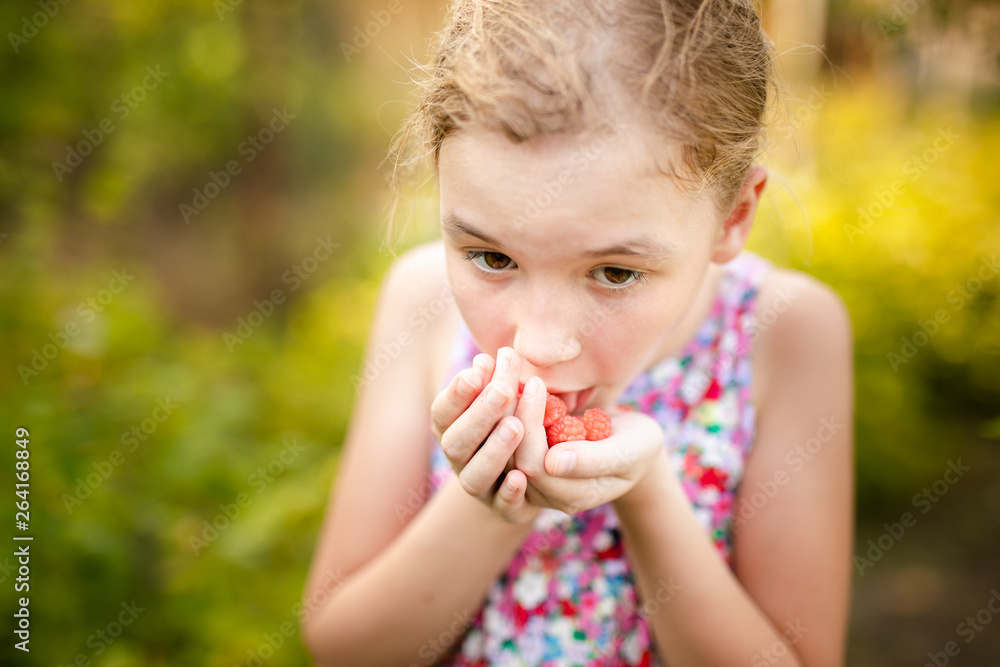 Little girl working in a small spring backyard garden with plants. Kid helping at the farm Little girl working in a small spring backyard garden with plants. Kid helping at the farm
