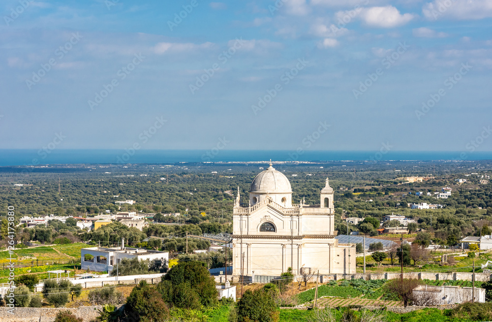 Italy, Ostuni, view of the church in the countryside among the olive trees.