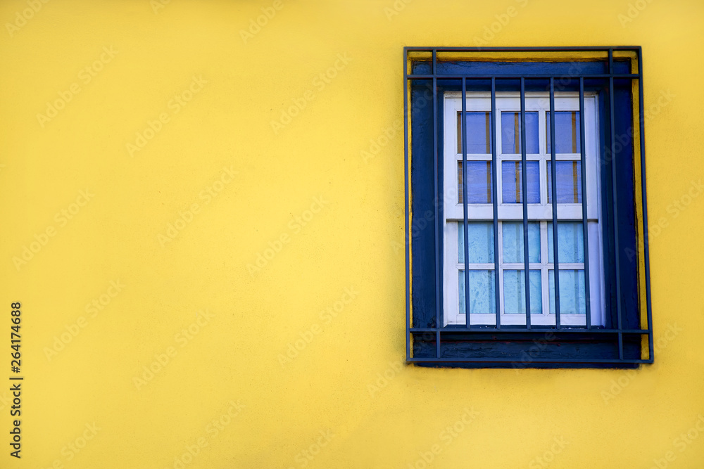 Fototapeta premium Colorful yellow house with blue shutters and window. In Porto, Portugal