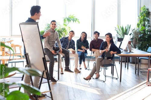 Students listening to teacher during seminar at university photo