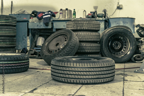 Replacing winter tires on summer tires in a professional garage with the help of professional tools. car on a hydraulic jack