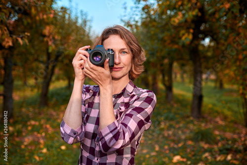 Pretty woman photographer in autumn park  © badahos