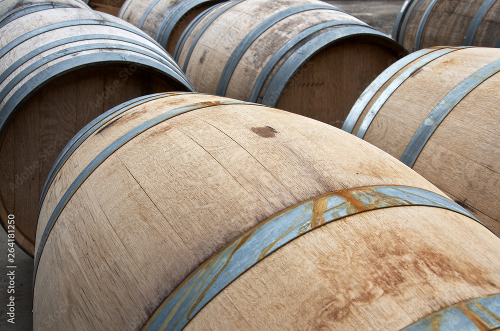close-up of wine wooden barrels in sunlight close-up of wine wooden barrels in sunlight