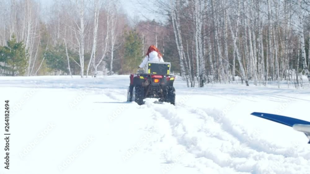 People in winter clothes riding snowmobiles outside People in winter clothes riding snowmobiles outside