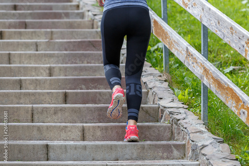 Female runner go up on stairs on jogging