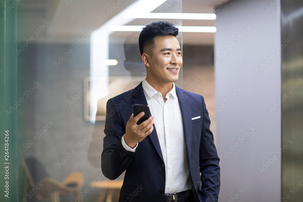 Confident young businessman using smart phone Confident young businessman using smart phone