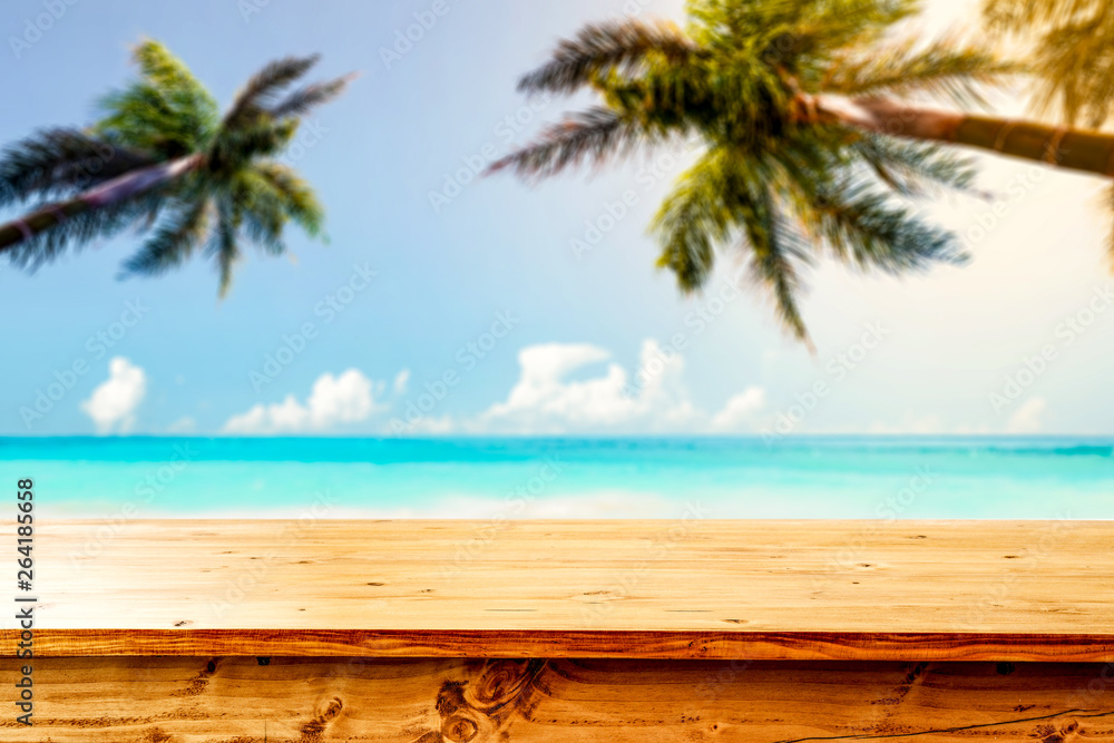 Desk of free space and summer beach with palms 