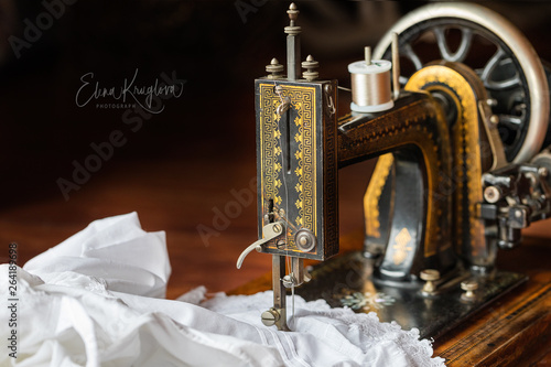 Process of sewing on the ancient sewing machine in the antiquarian case. Soft focus. 