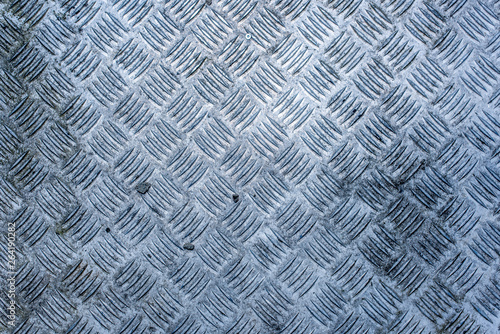 A dirty, worn and weathered diamond plate