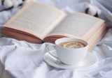 mug of hot tea and book