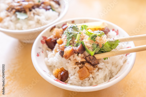 Braised pork over rice - Taiwan famous traditional street food delicacy. Soy-stewed pork on rice. Travel design concept. Top view,copy space,close up