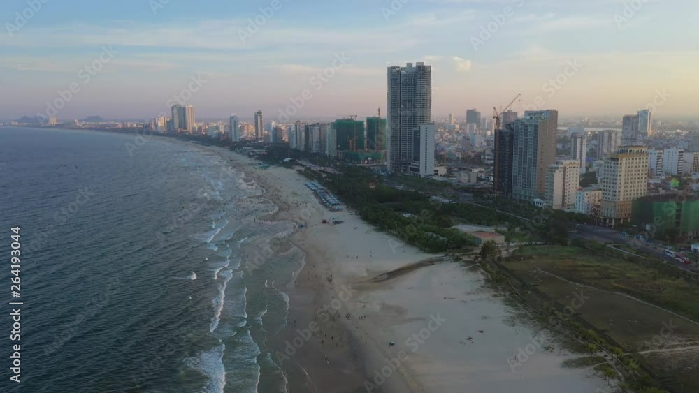 Aerial Flying View of Danang, Vietnam Skyline and Busy Beach at Sunset Aerial Flying View of Danang, Vietnam Skyline and Busy Beach at Sunset