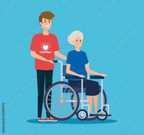 boy volunteer and old woman in the wheelchair