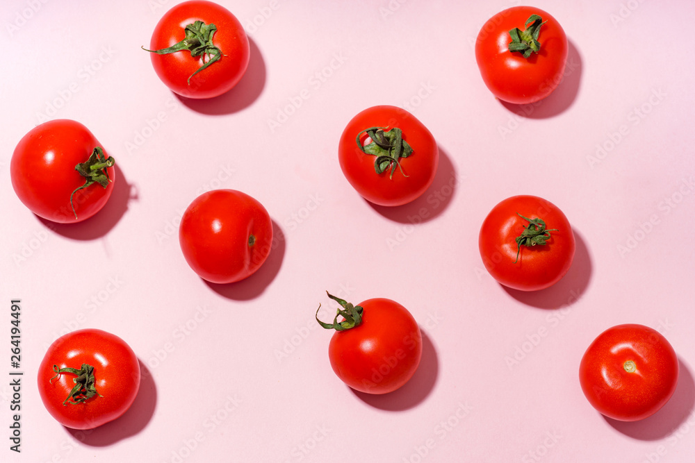 Pattern with cherry tomatoes on pink background Pattern with cherry tomatoes on pink background