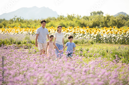 Happy young family in flower field photo