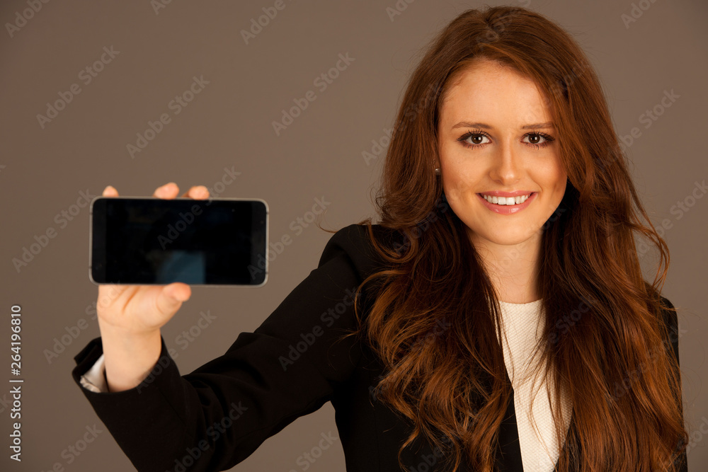 attractive business woman holds a tablet or smartphone wtih blank copy space for additional graphic or text attractive business woman holds a tablet or smartphone wtih blank copy space for additional graphic or text