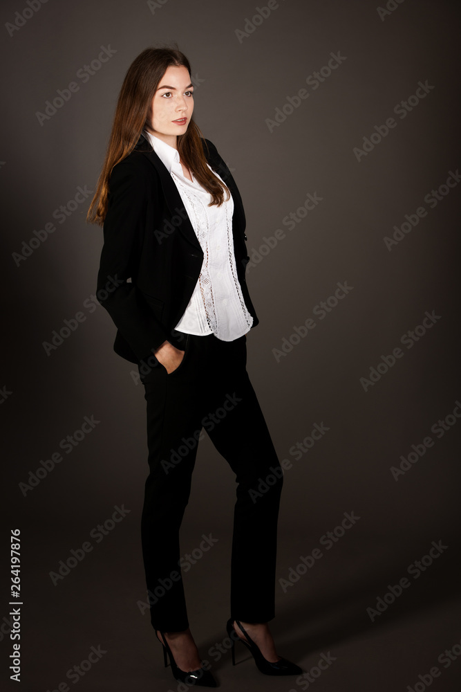 attractive business woman - full length corporative portrait islated over gray background attractive business woman - full length corporative portrait islated over gray background