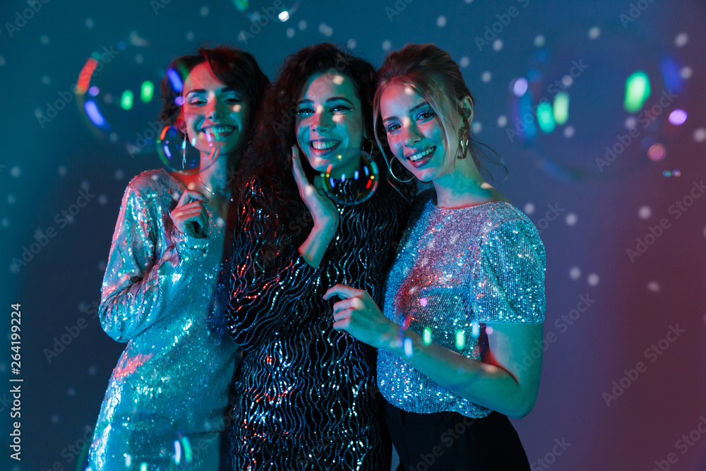 Happy Three beauty women wearing in shiny clothes - obrazy, fototapety, plakaty 