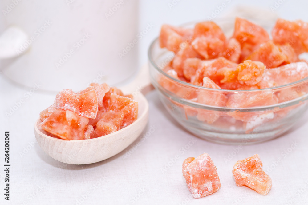 Homemade candied fruit from pumpkin in wooden spoon on white background. Healthy snack. Homemade candied fruit from pumpkin in wooden spoon on white background. Healthy snack.