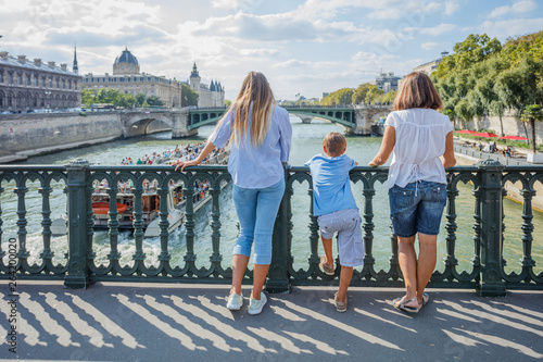 Happy family of three enjoying vacation in Paris, France photo